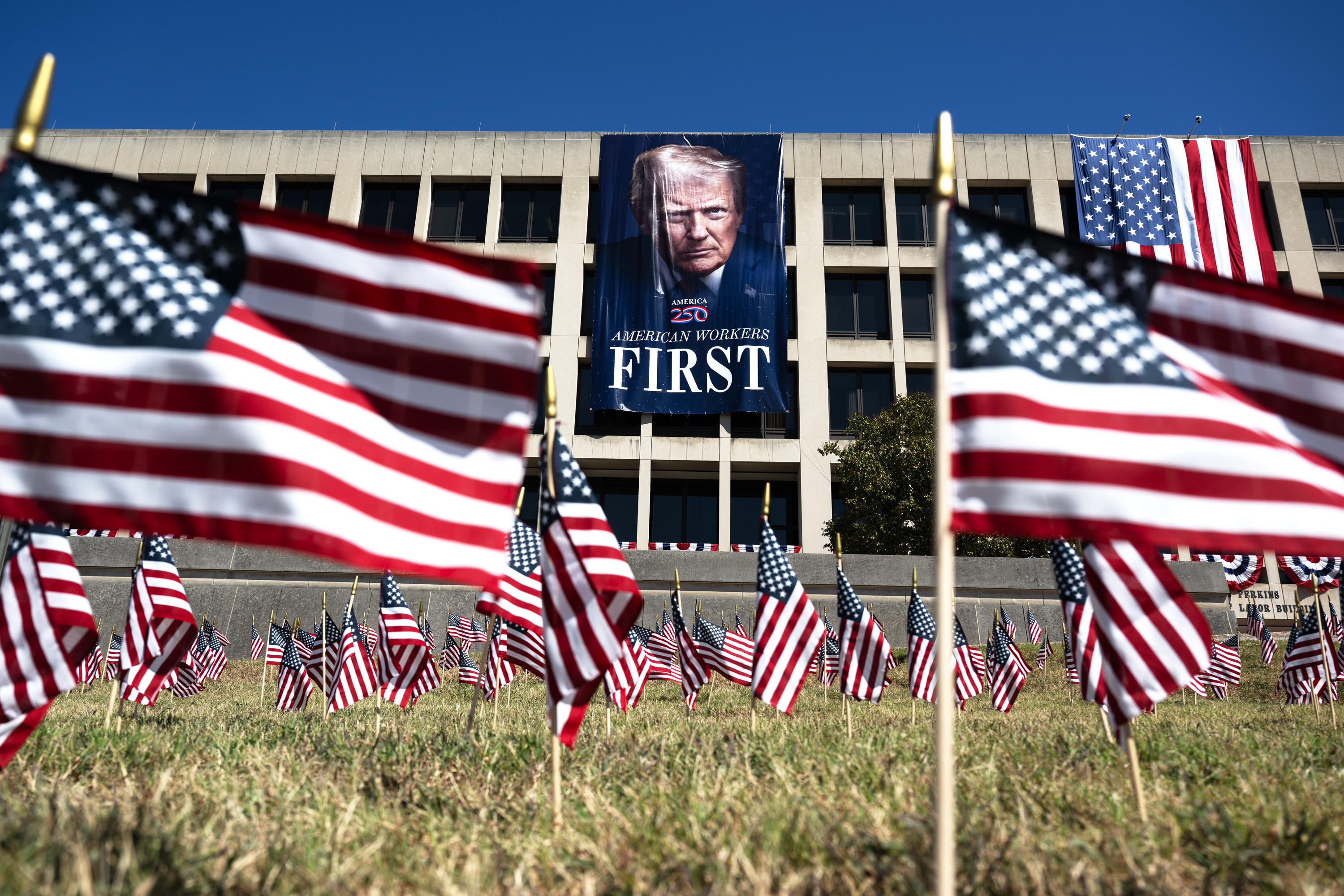 A banner of President Donald Trump hangs on the Labor Department headquarters in D.C. (Craig Hudson/For the Washington Post)