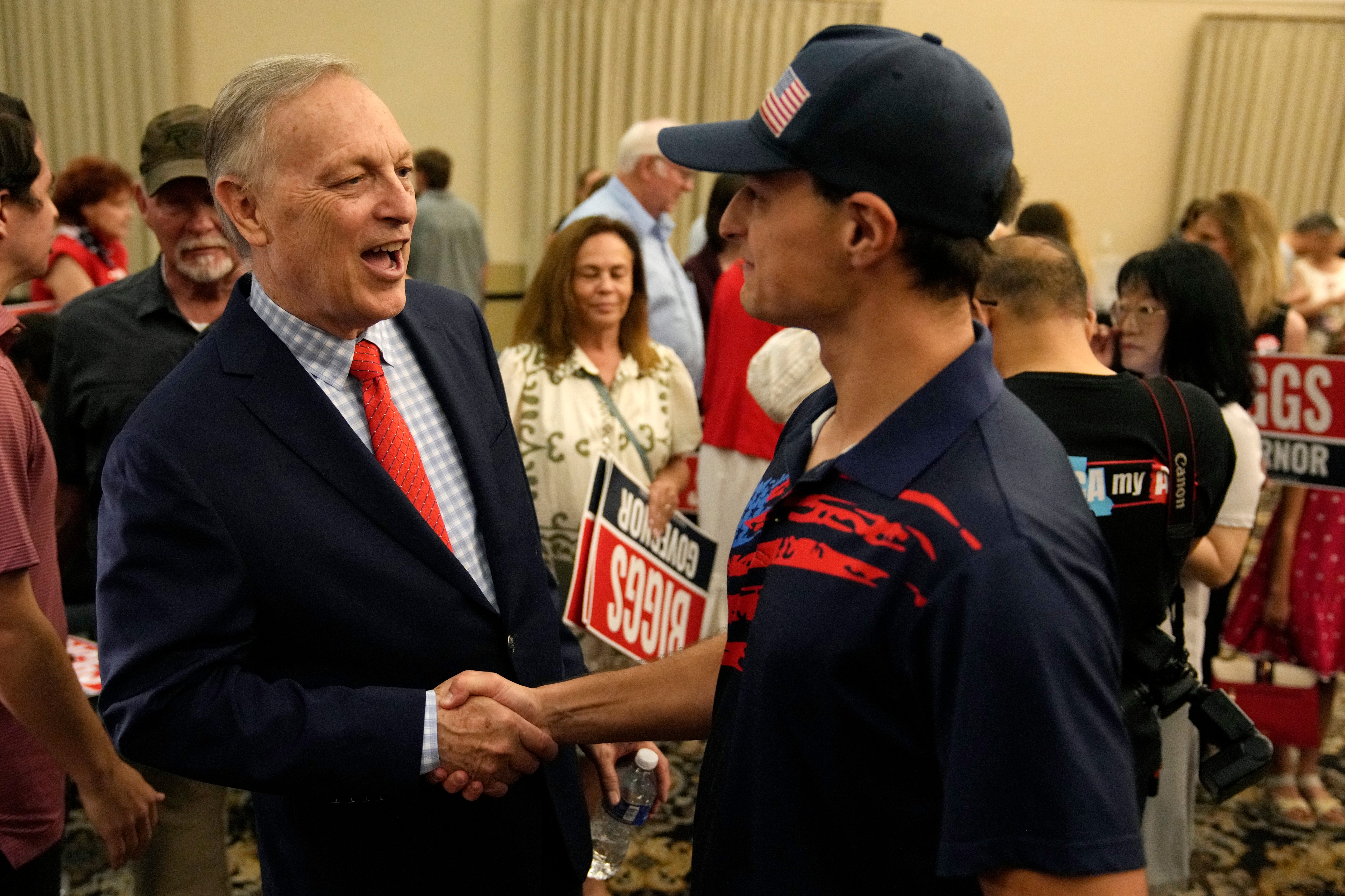 Rep. Andy Biggs, left, greets a supporter last week at a campaign event in Gilbert, Arizona. Biggs on Tuesday won the GOP nomination for governor. (Ross D. Franklin/AP)