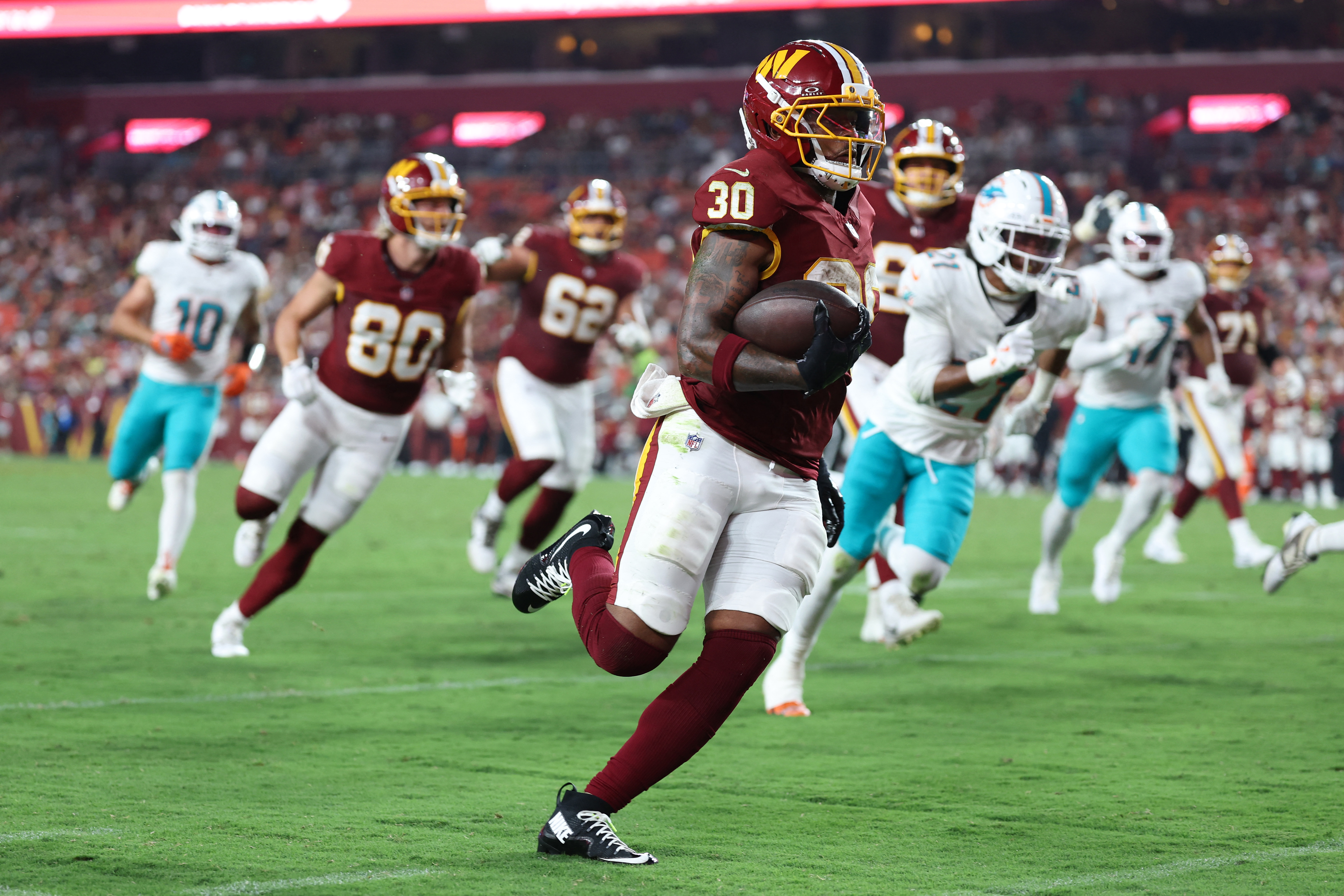 Commanders running back Robert Henry Jr. finds the end zone against the Dolphins on Friday night. (Amber Searls/Imagn Images/Reuters Connect)