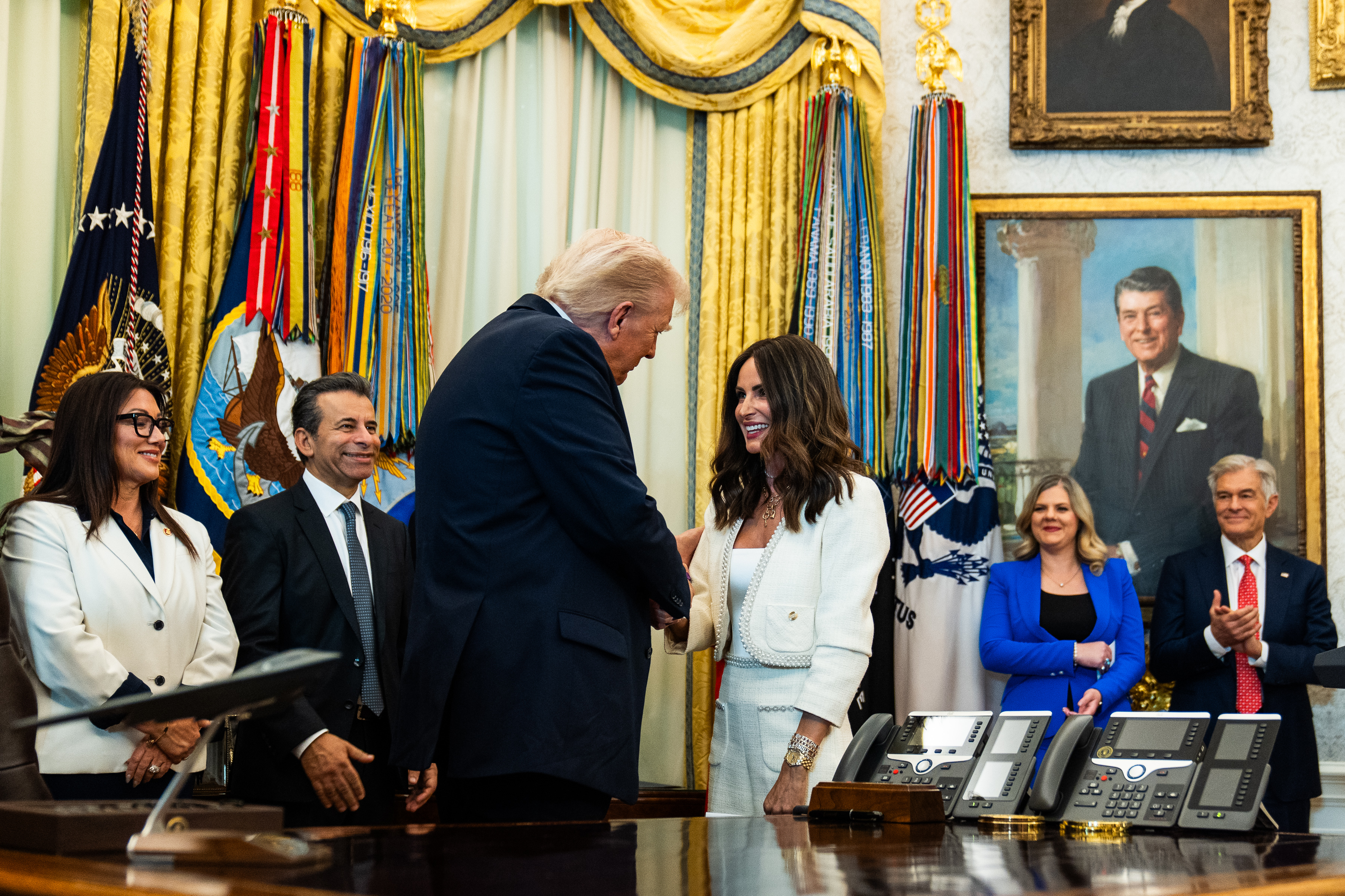 President Donald Trump greets in vitro fertilization advocate Samantha Busch during an October event in the Oval Office outlining plans to encourage employers to include IVF access in infertility coverage. (Demetrius Freeman/The Washington Post)