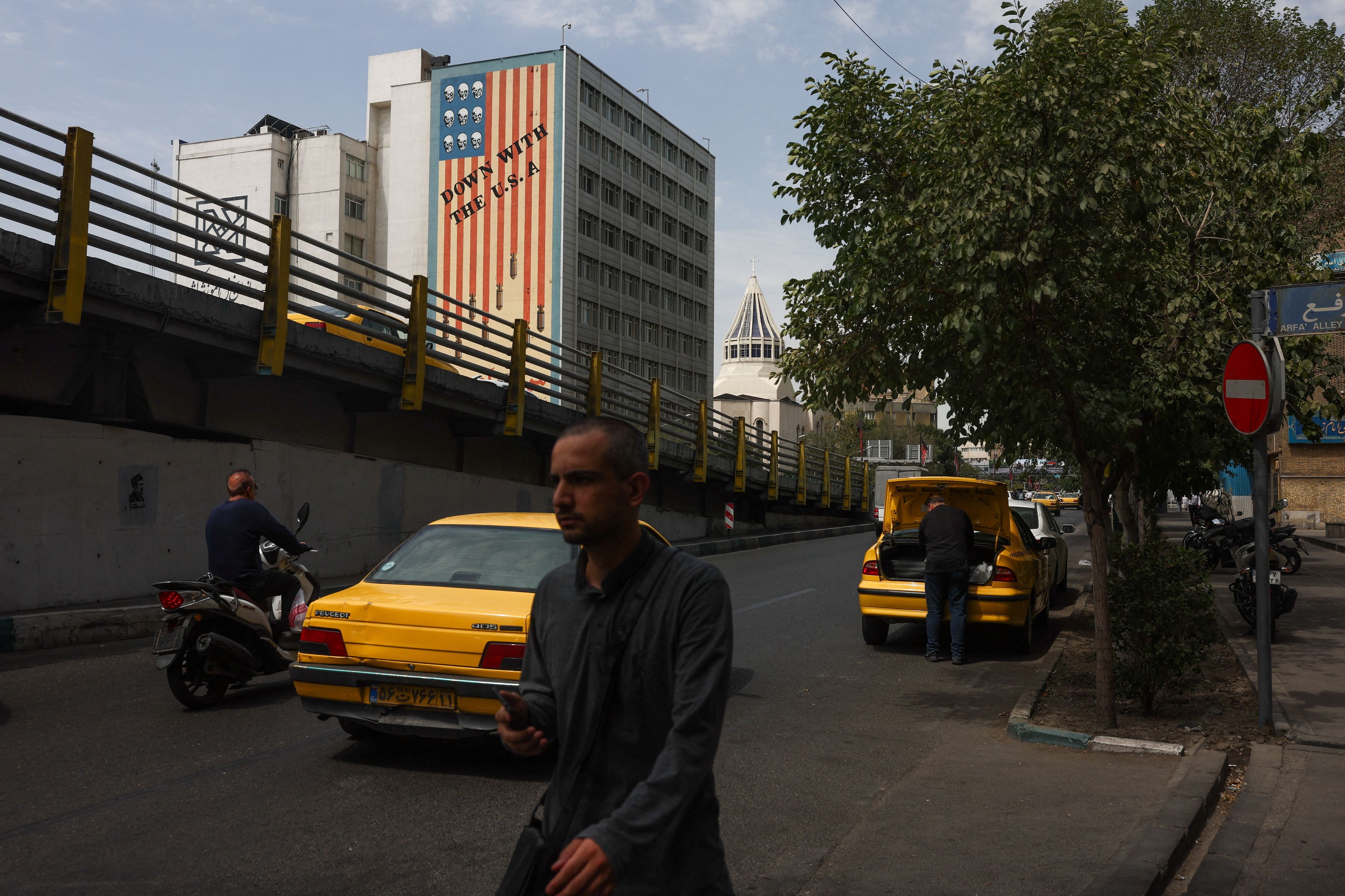 An anti-U.S. mural covers the side of a building in Tehran on Saturday. (Majid Asgaripour/West Asia News Agency/Reuters)