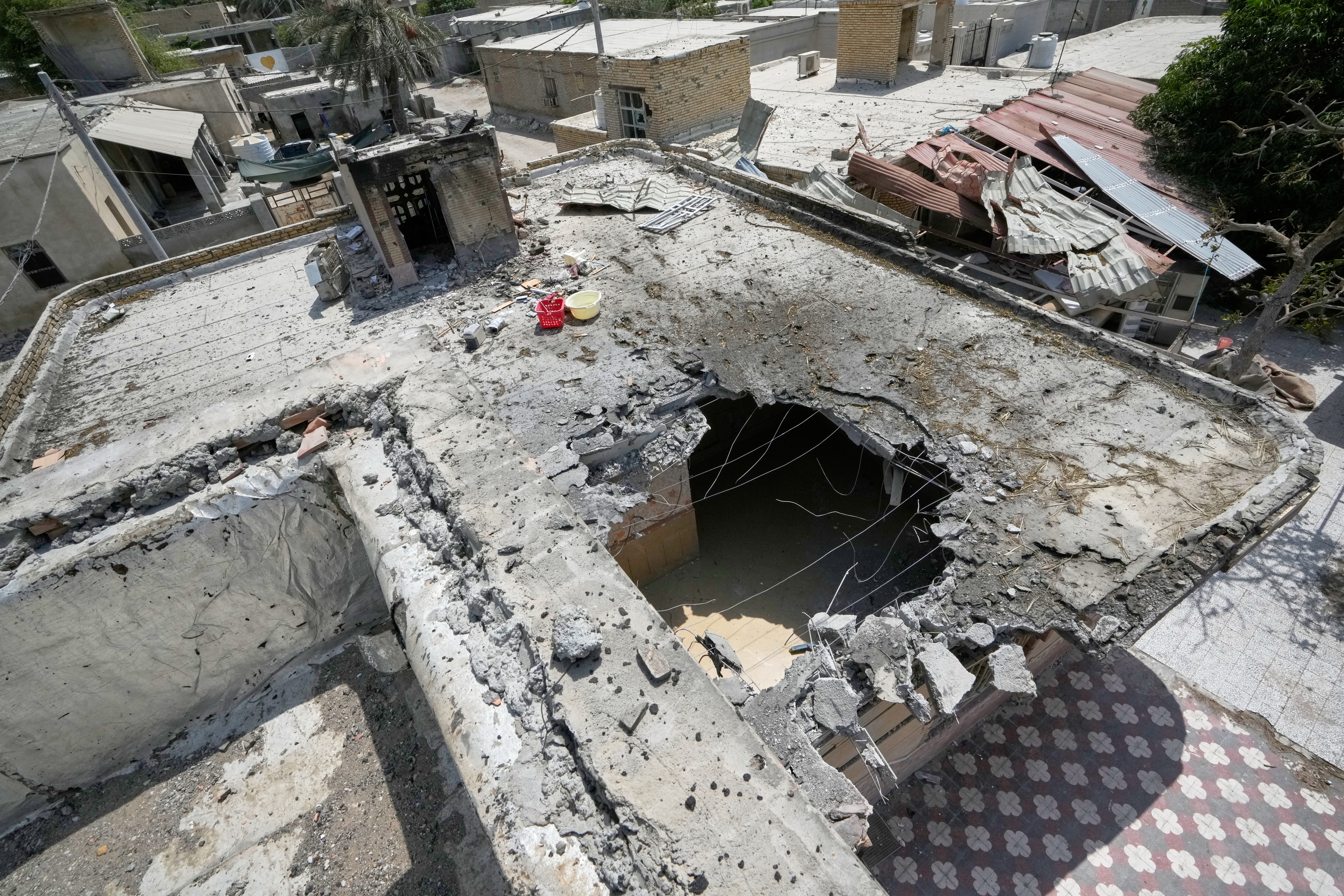 The point of impact on the roof of a building where a wedding celebration was taking place on Tuesday. (Vahid Salemi/AP)