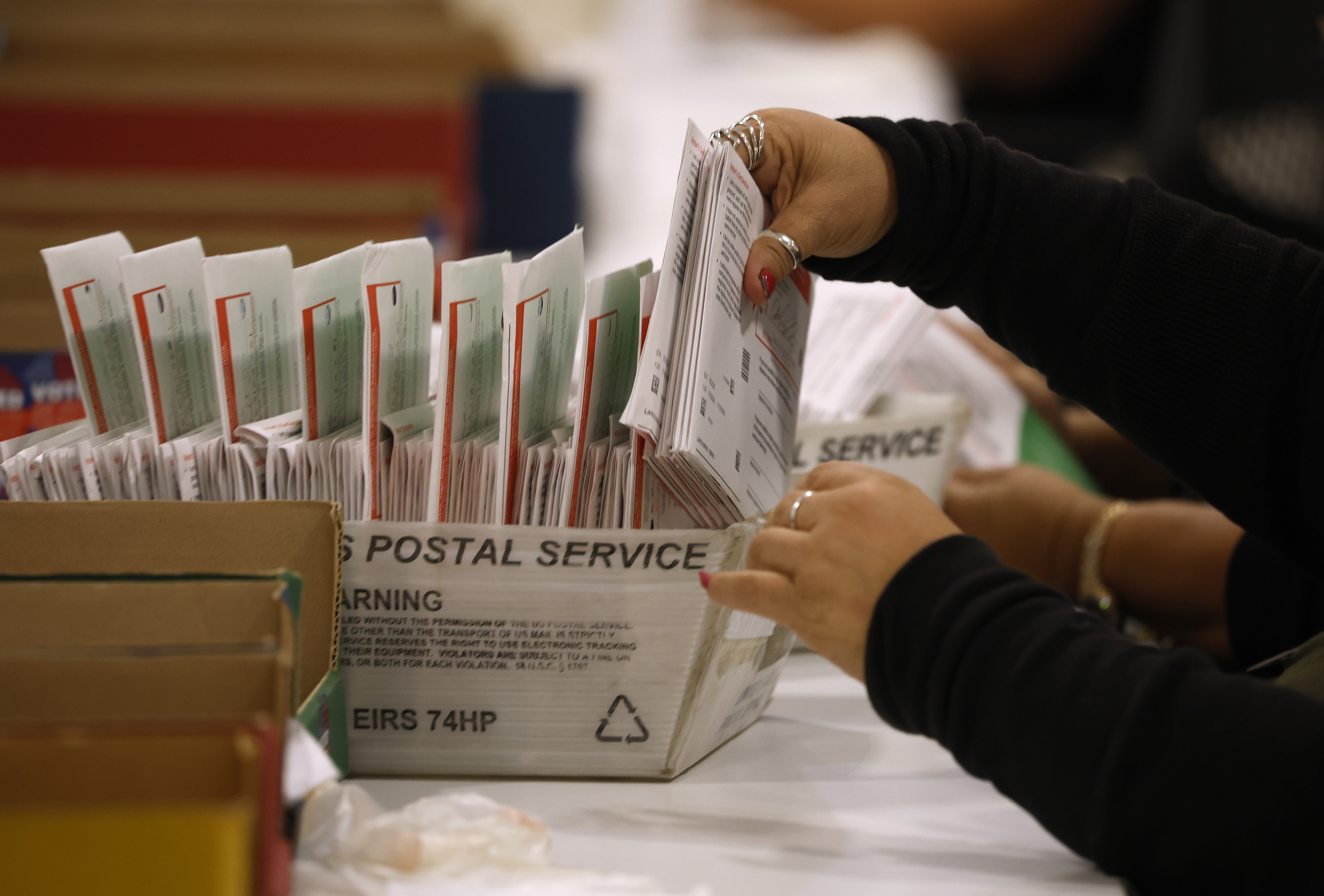 An election worker in June processes mail-in ballots in Industry, California. (Justin Sullivan/Getty Images)
